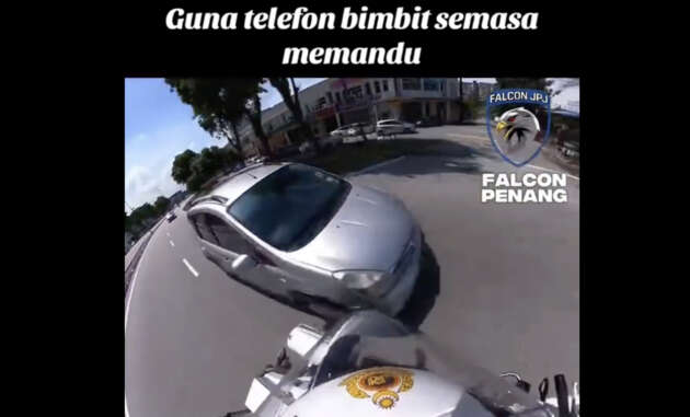 Seorang wanita disaman gara-gara guna telefon bimbit sambil memandu dan hampir terlanggar anggota JPJ