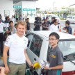 Mercedes GP F1 driver Nico Rosberg refuels lucky customers’ cars at Petronas’ 1,001st station